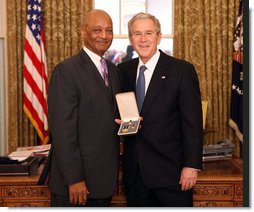 President George W. Bush stands with Bob Woodson, Sr., after presenting him with the 2008 Presidential Citizens Medal Wednesday, Dec. 10, 2008, in the Oval Office of the White House. White House photo by Chris Greenberg