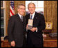 President George W. Bush stands with Robert "Robby" P. George after presenting him with the 2008 Presidential Citizens Medal Wednesday, Dec. 10, 2008, in the Oval Office of the White House. White House photo by Chris Greenberg