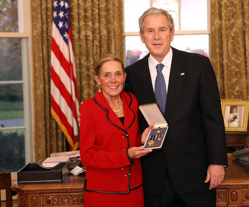 President George W. Bush stands with Kathy Downing after presenting her with the 2008 Presidential Citizens Medal Wednesday, Dec. 10, 2008, on behalf of her husband Gen. Wayne A. Downing, in the Oval Office of the White House. White House photo by Chris Greenberg
