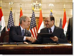 President George W. Bush and Iraqi Prime Minister Nuri al-Maliki shake hands following the signing of the Strategic Framework Agreement and Security Agreement at a joint news conference Sunday, Dec. 14, 2008, at the Prime Minister's Palace in Baghdad. President Bush said, " The agreements represent a shared vision on the way forward in Iraq."  White House photo by Eric Draper