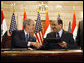 President George W. Bush and Iraqi Prime Minister Nuri al-Maliki shake hands following the signing of the Strategic Framework Agreement and Security Agreement at a joint news conference Sunday, Dec. 14, 2008, at the Prime Minister's Palace in Baghdad. President Bush said, " The agreements represent a shared vision on the way forward in Iraq." White House photo by Eric Draper