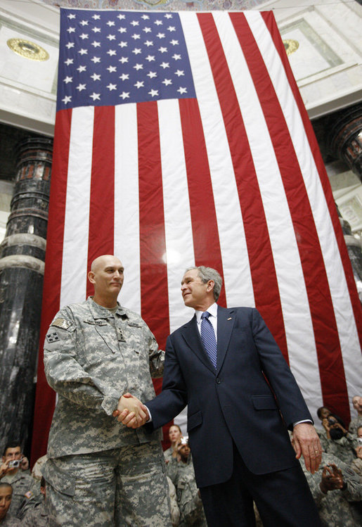 President George W. Bush stands on stage with U.S. Commander in Iraq, General Ray Odierno, Sunday, Dec. 14, 2008, following his address to U.S. military and diplomatic personnel at the Al Faw Palace-Camp Victory in Baghdad. White House photo by Eric Draper