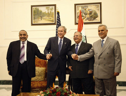 President George W. Bush poses for photos with Iraq's President Jalal Talabani, left, and Iraq Vice Presidents Adil Abdul-Mahdi and Tariq al-Hashimi, right, during their meeting Sunday, Dec. 14. 2008, at the Salam Palace in Baghdad. White House photo by Eric Draper