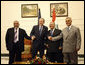 President George W. Bush poses for photos with Iraq's President Jalal Talabani, left, and Iraq Vice Presidents Adil Abdul-Mahdi and Tariq al-Hashimi, right, during their meeting Sunday, Dec. 14. 2008, at the Salam Palace in Baghdad. White House photo by Eric Draper