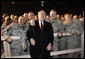 President George W. Bush pauses for photos with troops at Bagram Air Base Monday, Dec. 15, 2008, in Afghanistan. The President made the pre-dawn visit to the base before meeting with President Hamid Karzai in Kabul. During his remarks to the troops, the President said, "What you're doing in Afghanistan is important, it is courageous, and it is selfless. It's akin to what American troops did in places like Normandy and Iwo Jima and Korea. Your generation is every bit as great as any that has come before. And the work you do every day is shaping history for generations to come." White House photo by Eric Draper