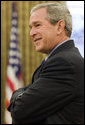 President George W. Bush stands in the Oval Office Dec. 13, 2006. White House photo by Eric Draper