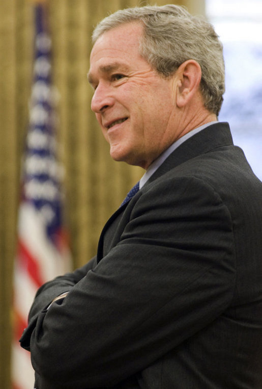 President George W. Bush stands in the Oval Office Dec. 13, 2006. White House photo by Eric Draper