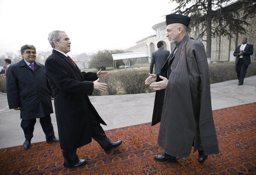 President George W. Bush is greeted by President Hamid Karzai upon arrival Monday morning, Dec. 15, 2008, at the Afghanistan leader's presidential palace in Kabul. White House photo by Eric Draper