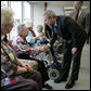 President George W. Bush and Senator Charles, Grassley, R-Iowa, greet residents at Wesley Acres Senior Center in Des Moines, Iowa, Tuesday, April 11, 2006. The President visited Iowa to talk about the Medicare prescription drug benefits. White House photo by Eric Draper