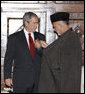 President George W. Bush is presented the Ghazi Amir Amanullah Khan Insignia by Afghanistan's President Hamid Karzai Monday, Dec. 15, 2008, for his efforts in rebuilding the country. The presentation came during a surprise visit to Kabul about which the President said, "I want to be in Afghanistan to say 'thank you' to President Karzai, to let the people of Afghanistan know that the United States has stood with them and will stand with them." White House photo by Eric Draper