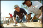 President George W. Bush helps raise a house during a visit June 5, 2001, to a Habitat for Humanity location in Tampa. White House photo by Eric Draper