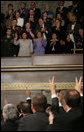 Safia Taleb al-Suhail, a guest of President and Mrs. Bush, holds up stained fingers marking her vote in Iraq elections as members of Congress, in a show of support, hold up fingers stained during the State of the Union, Feb. 2, 2005. White House photo by Eric Draper