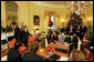 President George W. Bush and Mrs. Laura Bush stand in the Yellow Oval Room in the Private Residence of the White House Thursday, Dec. 18, 2008, after the President dropped in on a coffee in honor of the U.S. Afghan Women's Council. White House photo by Joyce N. Boghosian