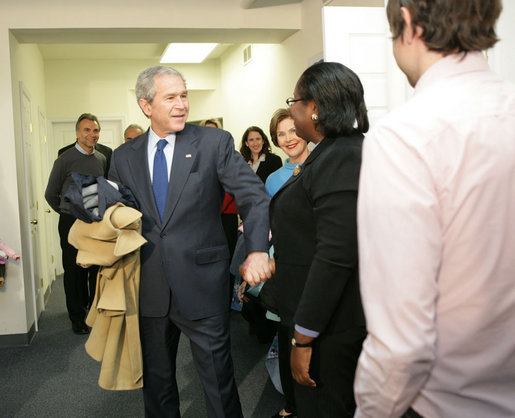 With Mrs. Laura Bush by his side, President George W. Bush speaks to reporters Monday, Dec. 22, 2008, during a visit to the Pathways to Housing DC, a distribution site for the One Warm Coat Holiday Service Project, in Washington, D.C. Modeled after the first Pathways to Housing program in New York City founded in 1992, Pathways to Housing DC works with individuals who have been turned away from other programs. White House photo by Shealah Craighead