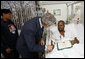 President George W. Bush shakes the hand of U.S. Army Sgt. First Class Neal Boyd of Haynesville, La., after presenting him a Purple Heart during a visit Monday, Dec. 22, 2008, to Walter Reed Army Medical Center, where the soldier is recovering from injuries received in Operation Iraqi Freedom. Looking on is SFC Boyd's wife, Joyce. White House photo by Eric Draper
