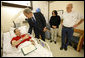 President George W. Bush shakes the hand of U.S. Army PFC Lukas Shook of Strafford, Mo., after presenting him with a Purple Heart Monday, Dec. 22, 2008, during a visit to Walter Reed Army Medical Center, where the soldier is recovering from injuries received in Operation Iraqi Freedom. Looking on are PFC Shook's mother and father, Dennis and Cynthia Shook. White House photo by Eric Draper