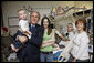 President George W. Bush holds 15-month-old James Jensen, son of Purple Heart recipient U.S. Army Cpl. Isaac Jensen of Layton, Utah, background-right, while posing for a photo Monday, Dec. 22, 2008 with Cpl. Jensen, his wife, Bethany and his mother, Eva Francis, right, during President Bush's visit to Walter Reed Army Medical Center in Washington, D.C. Jensen is recovering from injuries sustained while serving in support of Operation Iraqi Freedom. White House photo by Eric Draper