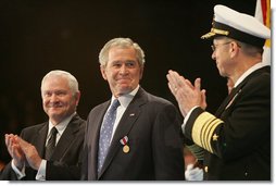 President George W. Bush glances at Admiral Mike Mullen, Chairman of the Joint Chiefs of Staff, as they stand with U.S. Secretary of Defense Robert Gates during a military tribute Tuesday, Jan. 6, 2009, at Ft. Myer in Arlington, Va.  White House photo by Joyce N. Boghosian