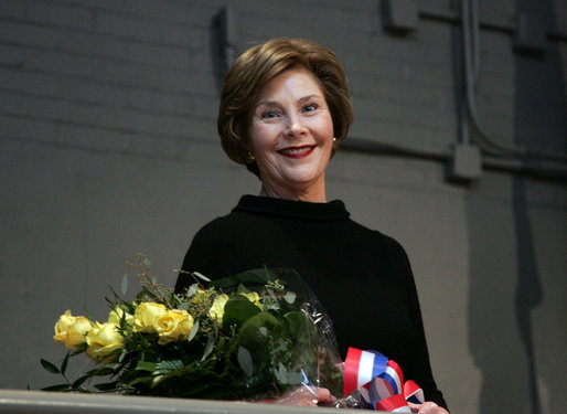 Mrs. Laura Bush stands with a bouquet presented along with the Department of Defense Outstanding Public Service Award by U.S. Secretary of Defense Robert Gates during a military appreciation Tuesday, Jan. 6, 2009, in honor of President George W. Bush's tenure as Commander-in-Chief. White House photo by Joyce N. Boghosian