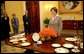 Mrs. Laura Bush meets reporters as she announces two new White House china patterns, Wednesday, Jan. 7, 2009 in the Family Dining Room of the State Floor of the White House for their unveiling of the George W. Bush State China and the Magnolia Residence China. The George W. Bush State China was inspired from a Madison-era dinner service. The Magnolia Residence China is in the picture foreground and the George W. Bush State China is on the left side of the table. With Mrs. Bush from left are Amy Zantzinger, White House Social Secretary, Nancy Clarke, White House Florist, and Bill Allman, White House Curator. White House photo by Shealah Craighead
