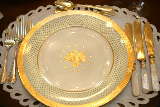 The George W. Bush State China, unveiled Wednesday, Jan. 7, 2009, at the White House by Mrs. Laura Bush, has a gold rim with a green basket-weave pattern and a historically-inspired gold eagle throughout the 14-piece place setting. The 320-place setting pattern will allow the White House to accommodate larger Rose Garden dinners and cover any breakage. The china was paid for by the White House Historical Association Acquisition Trust, a non-profit organization. White House photo by Shealah Craighead