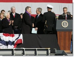 President George W. Bush shakes hands with his father, former President George H.W. Bush following President Bush's remarks in honor of his father at the commissioning ceremony of the USS George H.W. Bush (CVN 77) aircraft carrier Saturday, Jan 10, 2009 in Norfolk, Va. White House photo by Joyce N. Boghosian