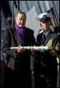 Former President George H.W. Bush presents a long glass to the First Officer of the Deck to set the first watch Saturday, Jan. 10, 2009, during commissioning ceremonies for the USS George H.W. Bush (CVN 77) aircraft carrier in Norfolk, Va. White House photo by David Bohrer