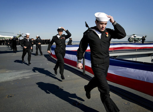 The crew of the USS George H.W. Bush (CVN 77) aircraft carrier ceremonially run aboard as the ship "comes alive" Saturday, Jan. 10, 2009, during commissioning ceremonies in Norfolk, Va. White House photo by David Bohrer
