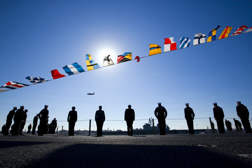 U.S. Navy Sailors line the deck of the the USS George H.W. Bush (CVN 77) aircraft carrier as a World War II Avenger Torpedo bomber similar to the plane flown by former President George H.W. Bush does a flyby Saturday, Jan. 10, 2009, during commissioning ceremonies in Norfolk, Va. White House photo by David Bohrer