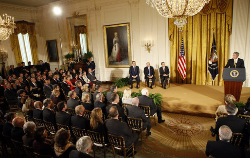 President George W. Bush speaks on stage in the East Room of the White House Tuesday, Jan. 13, 2009, during the Ceremony for the 2009 Recipients of the Presidential Medal of Freedom. With him on stage are the recipients, from left: Former Prime Minister Tony Blair of the United Kingdom, former Prime Minister John Howard of Australia, and President Alvaro Uribe of Colombia. White House photo by Chris Greenberg