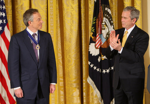 President George W. Bush applauds former Prime Minister Tony Blair after presenting him Tuesday, Jan. 13, 2009, with the 2009 Presidential Medal of Freedom during ceremonies in the East Room of the White House. White House photo by Chris Greenberg