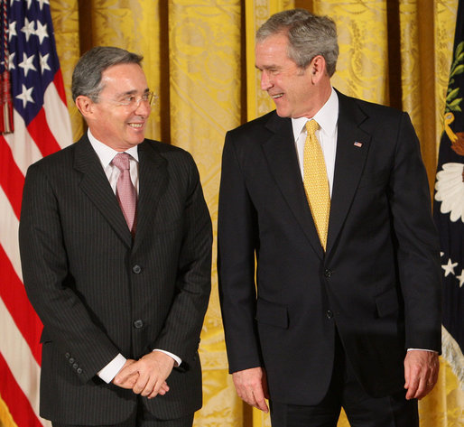 President George W. Bush stands with Colombian President Alvaro Uribe Tuesday, Jan. 13, 2009, during ceremonies honoring the 2009 Presidential Medal of Freedom Recipients in the East Room of the White House. White House photo by Chris Greenberg