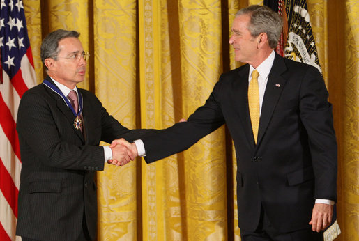 President George W. Bush congratulates President Alvaro Uribe of Colombia after presenting him with the 2009 Presidential Medal of Freedom Tuesday, Jan. 13, 2009, during ceremonies in the East Room of the White House. White House photo by Chris Greenberg