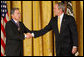 President George W. Bush congratulates President Alvaro Uribe of Colombia after presenting him with the 2009 Presidential Medal of Freedom Tuesday, Jan. 13, 2009, during ceremonies in the East Room of the White House. White House photo by Chris Greenberg