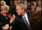 President George W. Bush reaches into the audience to shake hands with invited guests and staff members following his farewell address to the nation Thursday evening, Jan. 15, 2009 in the East Room of the White House, where President Bush thanked the American people for their support and trust. White House photo by Joyce N. Boghosian
