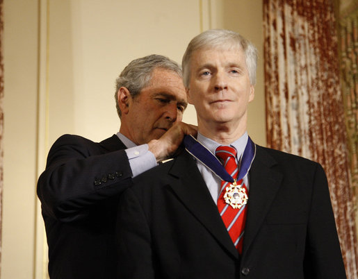 President George W. Bush places the Presidential Medal of Freedom to U.S. Ambassador to Iraq Ryan Crocker during a ceremony Thursday, Jan. 15, 2009, at the U.S. Department of State to commemorate foreign policy achievements. White House photo by Eric Draper