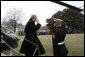 President George W. Bush salutes a U.S. Marine crew member of Marine One upon his return to the White House Sunday, Jan. 18, 2009 from Camp David, which marks President Bush's final return to the South Lawn of the White House aboard the Presidential helicopter as President. White House photo by Chris Greenberg