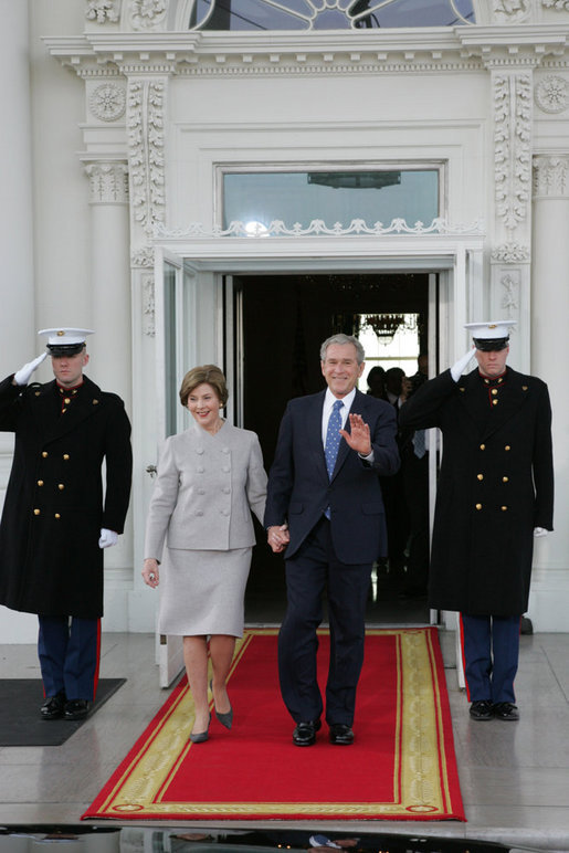 President George W. Bush and Mrs. Laura Bush walk out on the North Portico of the White House Tuesday morning, Jan. 20, 2009, to welcome President-Elect Barack Obama to the White House. White House photo by Joyce N. Boghosian