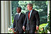 President George W. Bush and President Thabo Mbeki of South Africa walk along the colonnade to a joint press conference in the Rose Garden June 26, 2001. President Bush and President Mbeki agree that economic freedom and political freedom must go hand-in-hand to sustain peace and security.