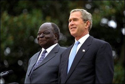 Presidents Bush and Kibaki watch the military review portion of the State Arrival Ceremonies on the South Lawn of the White House Monday, October 5, 2003.