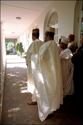 The Nigerian delegation stands along the colonnade as President George W. Bush talks with Nigerian President Olusegun Obasanjo May 11, 2001. President Bush thanked President Obasanjo for sending a message of tolerance and respect and assured him that the global war on terrorism is a fight against terror and evil and not against Muslims, whose Islamic faith teaches peace and respect for human life.
