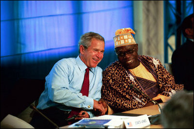 President George W. Bush talks with President Olusegun Obasanjo of Nigeria during a G8 Summit working session in Evian, France, June 1, 2003. The G8 leaders and the leaders of the New Partnership for Africa's Development (NEPAD) highlighted greater cooperation between the G8 and NEPAD and discussed challenges and opportunities going forward. President Bush and President Obasanjo are working together to forge an African Action Plan that removes obstacles of trade barriers, illiteracy, infectious disease, unsustainable debt and hunger. President Bush and President Obasanjo agreed that such a partnership must be based on mutual respect and responsibility. 