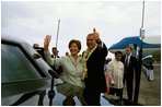 President George W. Bush and Laura Bush wave to a welcoming crowd at the Ninoy Aquino International Airport in Manila, Philippines, Saturday, Oct. 18, 2003.
