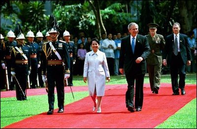 President George W. Bush and Philippine President Gloria Arroyo review troops during a welcoming ceremony at Malacanang Palace in Manila, Philippines, Saturday, Oct. 18, 2003. 
