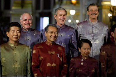 President George W. Bush stands with APEC leaders for their group photo in Bangkok, Thailand, Tuesday, Oct. 21, 2003. The leaders are, from left: President Roh Moo-hyun of South Korea, Prime Minister John Howard of Australia, Prime Minister Mahathir Mohamad of Malaysia, President Gloria Arroyo of the Philippines, President Vicente Fox of Mexico and Prime Minister Thaksin Shinawatra of Thailand. 