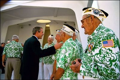 President George W. Bush greets veterans at the USS Arizona Memorial in Honolulu, Hawaii, Thursday, Oct. 23, 2003. The memorial honors those who served during the attack on Pearl Harbor Dec. 7, 1941. 