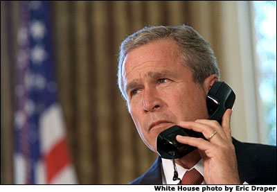 Pledging support for New York, President George Bush talks with Governor George Pataki and Mayor Rudolph Giuliani in a televised telephone conversation from the Oval Office Sept. 13. 