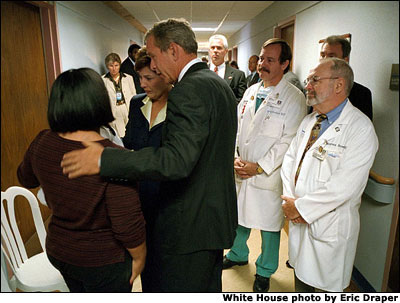 President Bush and Mrs. Laura Bush comfort family members at Washington Hospital Center Sept. 13. The President and First Lady visited the hospital to thank doctors and visit patients wounded in the attack on the Pentagon. White House Photo by Eric Draper.