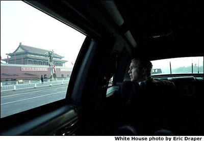Driving to a working breakfast, President George W. Bush looks out from his presidential limousine at the Forbidden City in China's capitol Friday, Feb. 22, 2002. White House photo by Eric Draper.