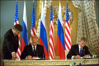 Presidents Bush and Putin sign a historic arms reduction treaty at the Kremlin in Moscow May 24. "President Putin and I have signed a treaty that will substantially reduce our nuclear -- strategic nuclear warhead arsenals to the range of 1,700 to 2,200, the lowest level in decades," said President Bush. "This treaty liquidates the Cold War legacy of nuclear hostility between our countries."